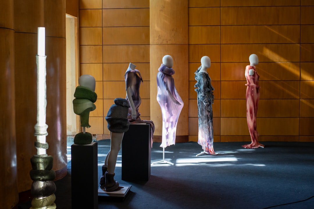 Fashion runway show with models walking in avant-garde designer clothing under dramatic lighting